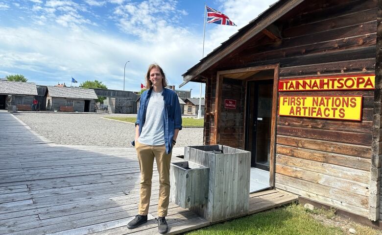 A man stands outside in a replica fort.