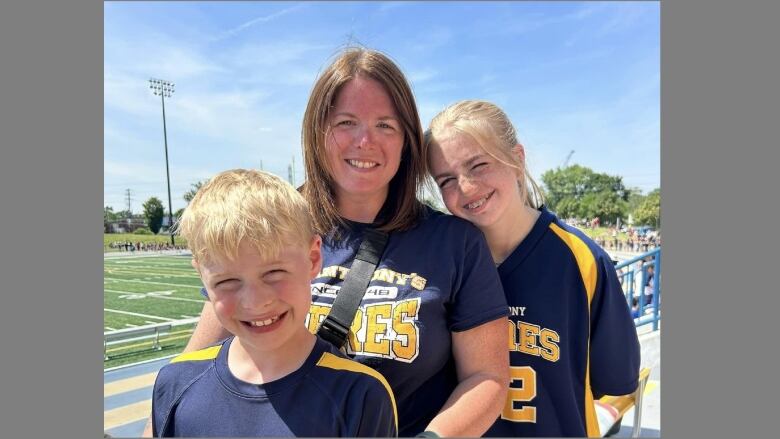 A woman and her children at a running sports track.