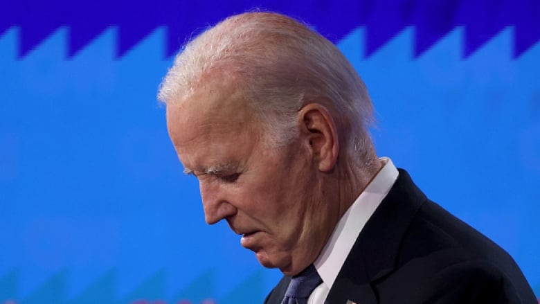 U.S. President Joe Biden looks down at his podium during a debate. 