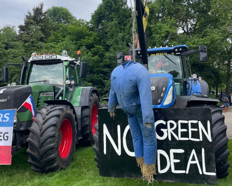 A tractor sits with a sign saying 