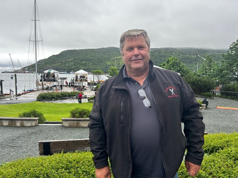 Man in jacket next to water