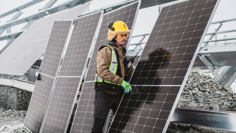 A worker hauls solar panels at the Diavik diamond mine in the N.W.T.