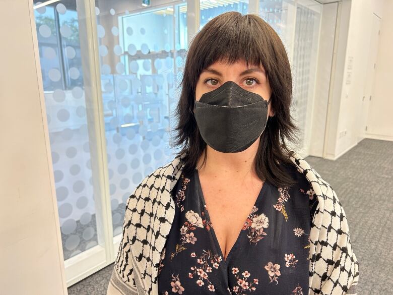 Woman wearing black mask.