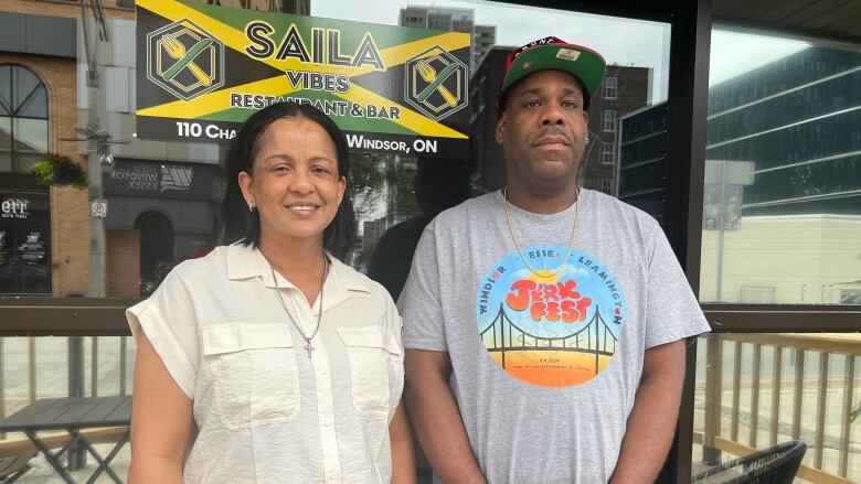 A man and a woman stand in front of the Saila Vibes restaurant in Windsor. 