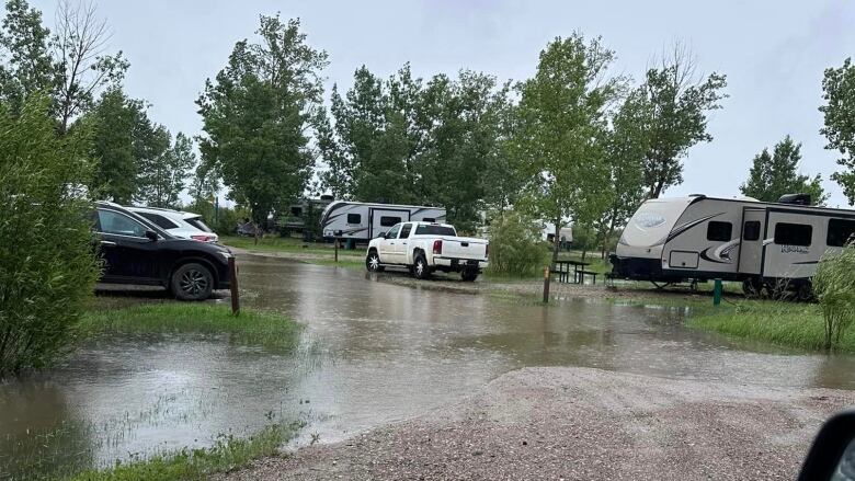 RVs and vehicles parked in puddles