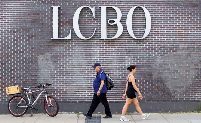 People walk past a Toronto LCBO location on July 4, 2024, ahead of a potential strike deadline.