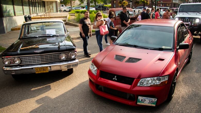 A car show fills a downtown street.