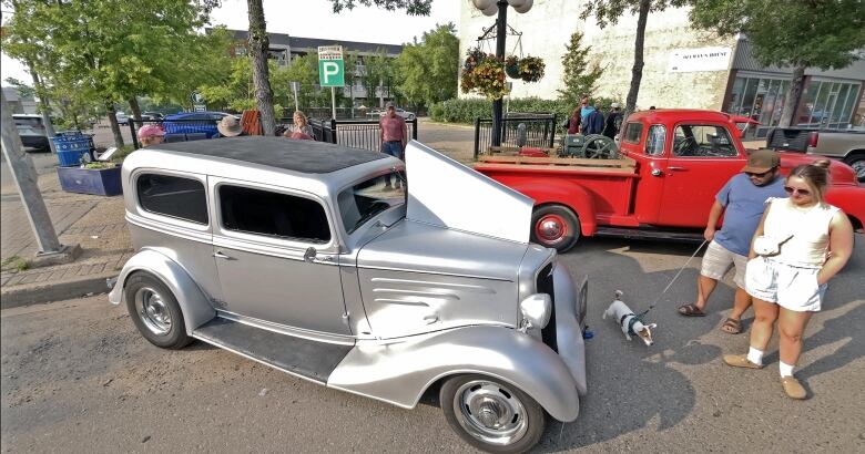 A car show on a downtown street.