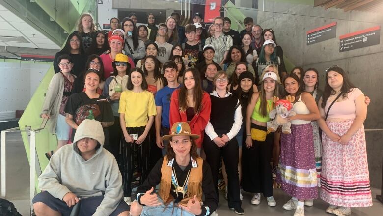 A group of students stand on stairs for a group photo. 