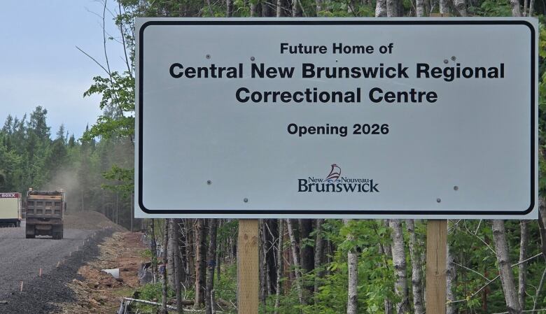 sign near construction site with a truck in the background 