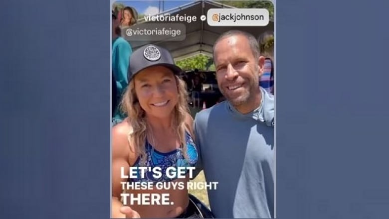 A man and woman in baseball caps smile for the camera.