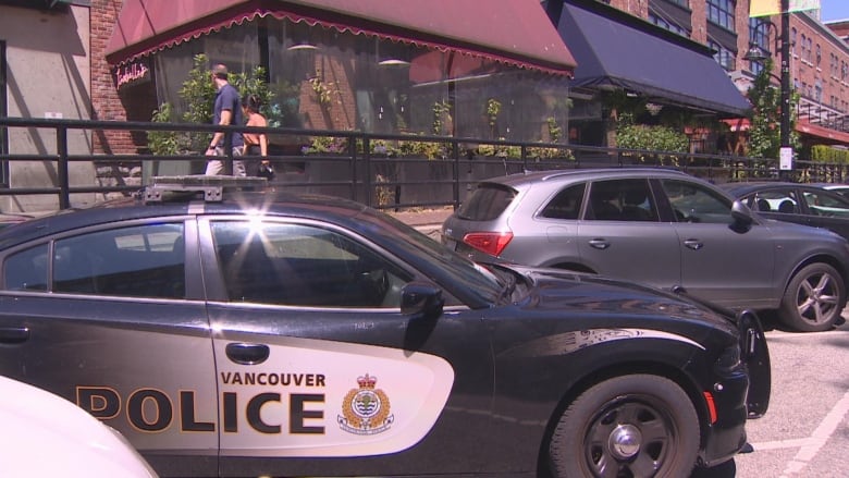 A VPD cruiser is parked outside a Yaletown bar.