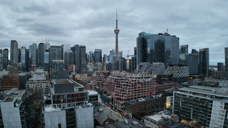 Aerial (drone) images of King St. West restaurant and bar strip, condo construction and CN Tower and skyline during evening.