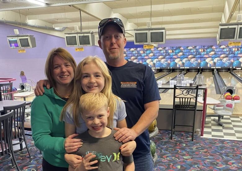 A family of four at a bowling alley.