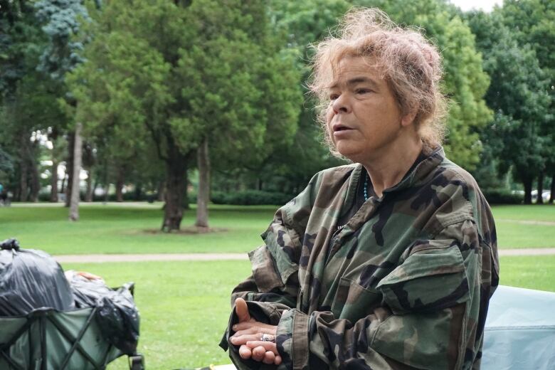 woman stands in park