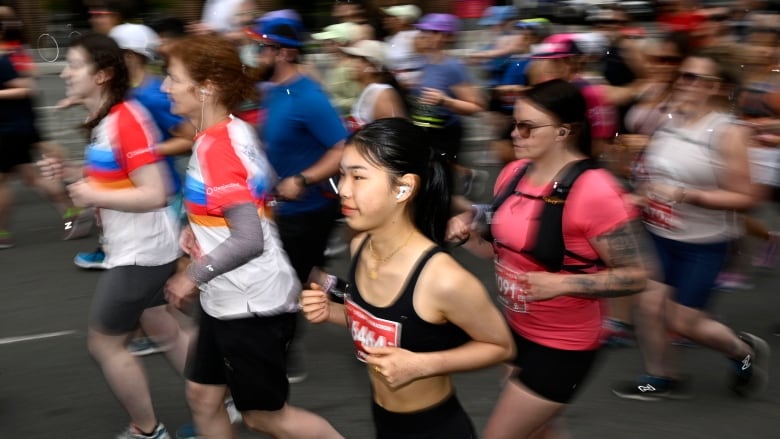 People run across a road in a marathon.