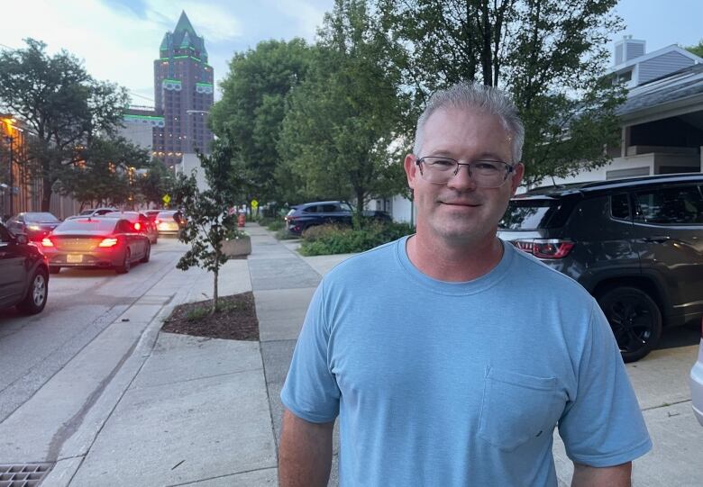 Middle-aged man standing on sidewalk