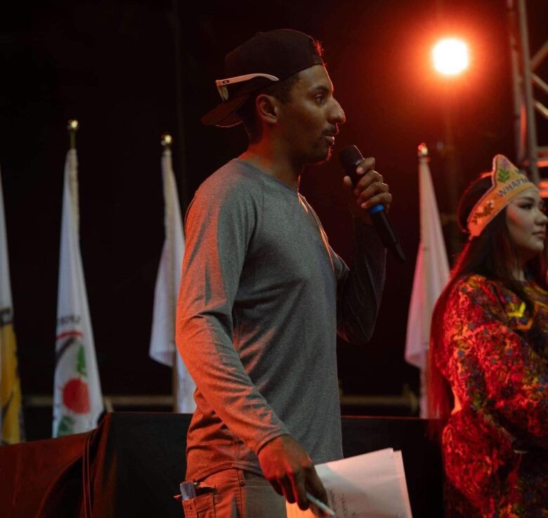 A Cree man speaks on stage