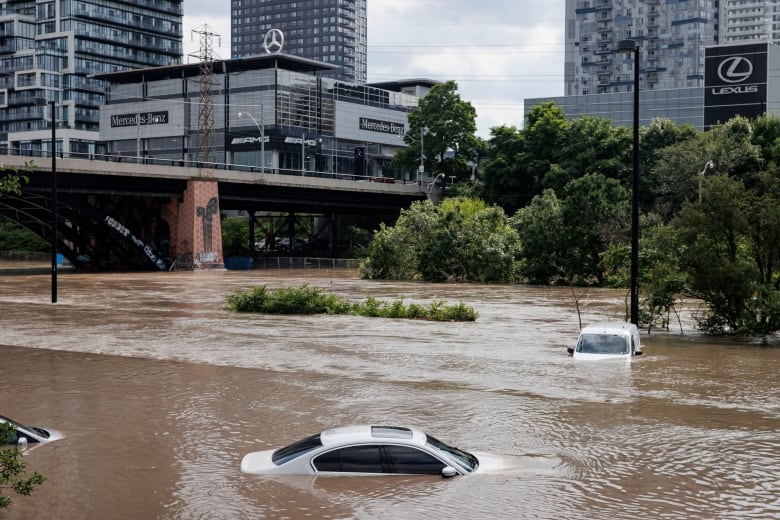 Photo of cars underwater in a flooded roadway