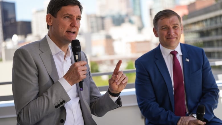 British Columbia Premier David Eby, left, speaks as Newfoundland and Labrador Premier Andrew Furey listens during a news conference at Bob & Michael's Place, a social housing complex in the Downtown Eastside of Vancouver, on Thursday, June 13, 2024.