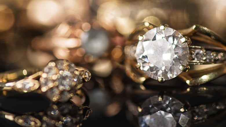 Gold jewelry on a black background.