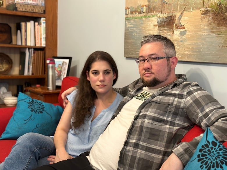 Man and woman sitting on couch