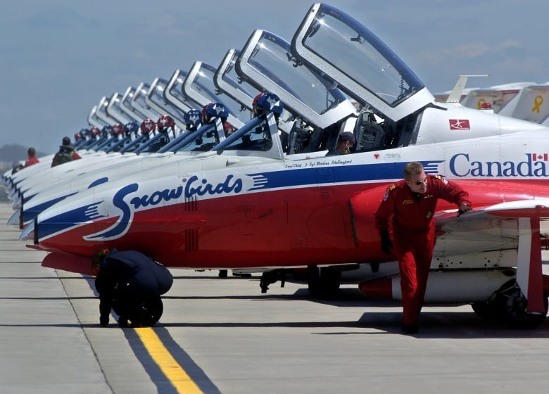 Maj. Robert Mitchell, right, lead pilot of the Canadian Forces Snowbirds, and Sgt. Marlene Shillingford, crew chief, perform a preflight inspection on their jet before takeoff from Great Falls International Airport, Friday afternoon, June 1, 2007, in Great Falls, Mont. The Snowbirds pilots arrived Thursday to retrieve their jets, which were grounded at the airport during an investigation into the May 18 crash that killed Capt. Shawn McCaughey, 31.