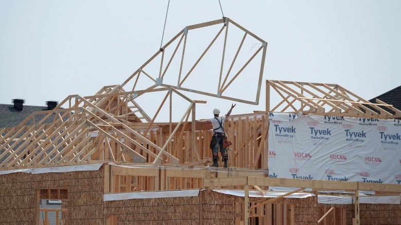 A man stands atop of a construction project.