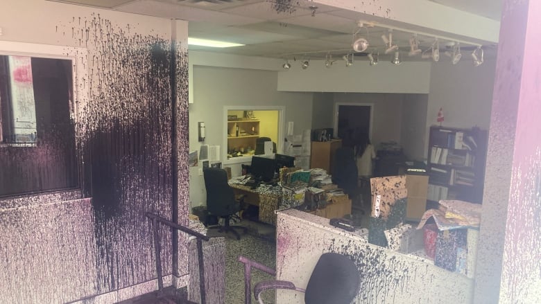 Black and pink paint sprayed on office walls