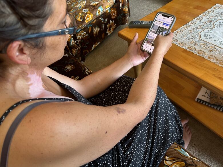 A woman looking into her phone.