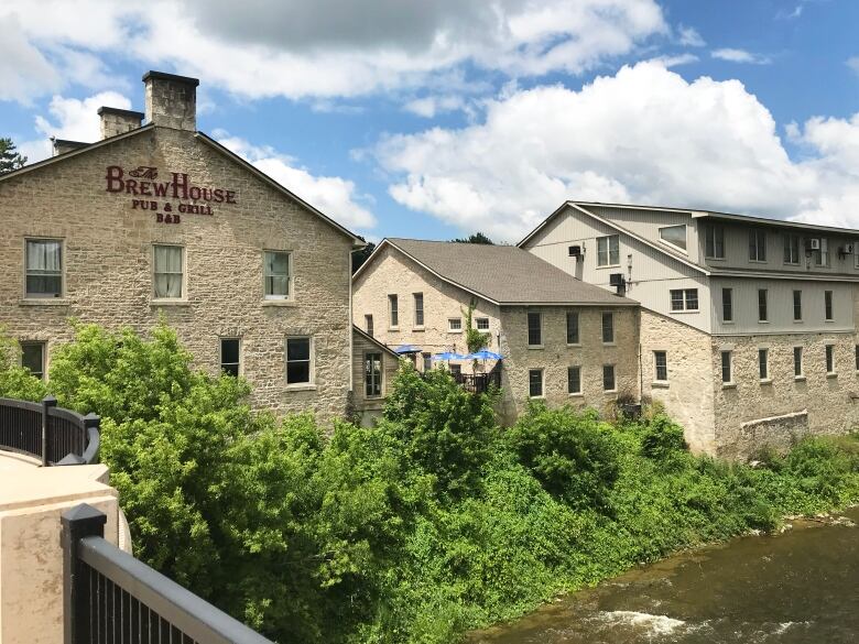 A large stone building by a river.