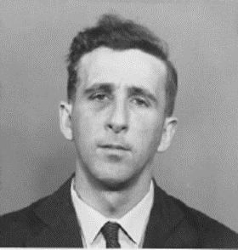 Black and white photo of a man wearing a suit