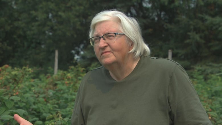  A woman stands in front of the camera.