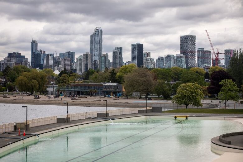 A large outdoor pool is pictured, with a skyline in the background.