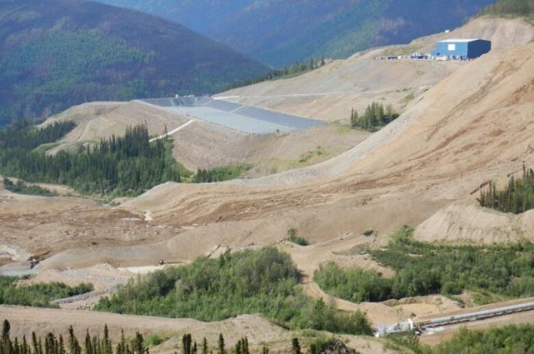 Ore material from the heap leach is pictured flowing across the Dublin Gulch waterway. 