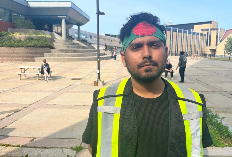 A man wearing a head band with the colours of the Bangladeshi flag