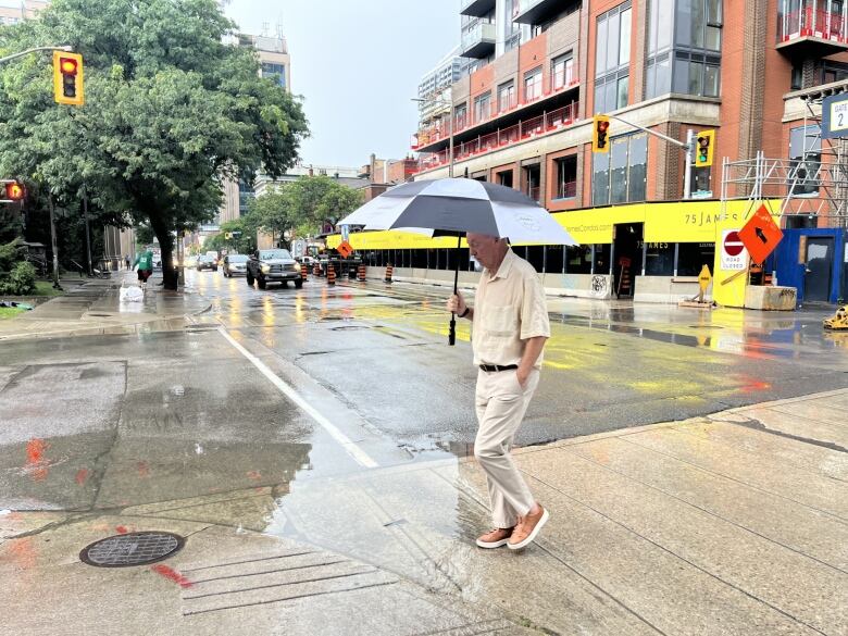 A man walking with an umbrella.