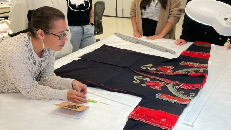 woman leaning next to antique jacket