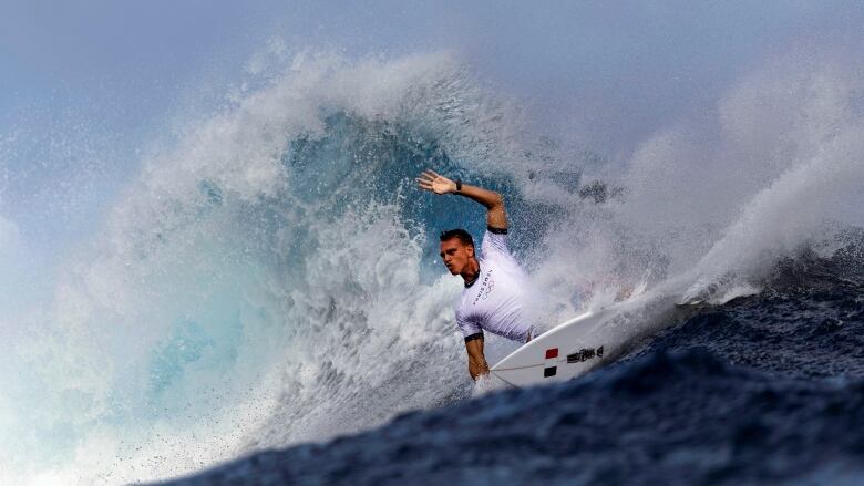 A surfer cuts back on a wave.