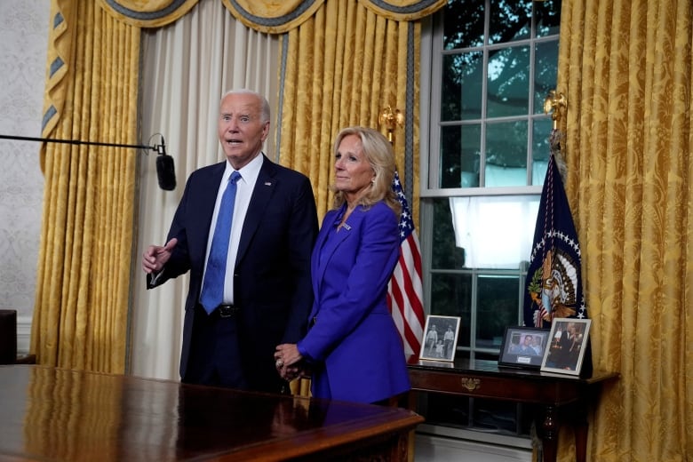 U.S. President Joe Biden stands next to First Lady Jill Biden.