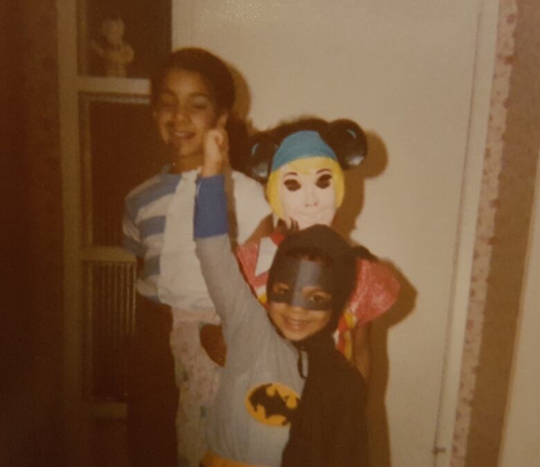 Three kids in costumes. 