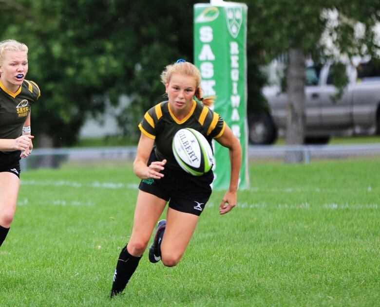 Carissa Norsten chasing a rugby ball while playing for Team Saskatchewan.