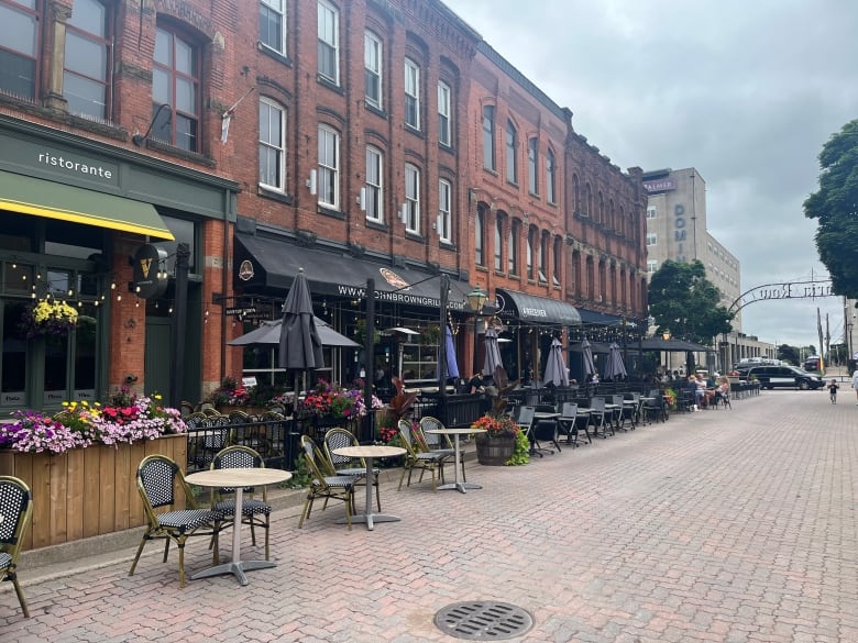 Restaurants without outdoor patios line a city street. 