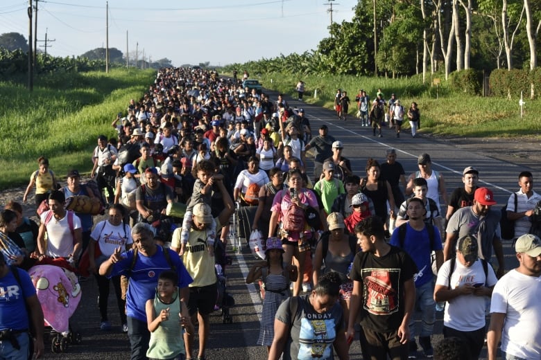 Migrants walk along the highway through Chiapas state in southern Mexico during their journey north toward the U.S. border on July 21, 2024.