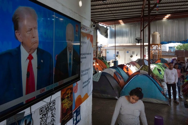 Migrants waiting to apply for asylum watch the presidential debate in a shelter for migrants, Thursday, June 27, 2024, in Tijuana, Mexico.