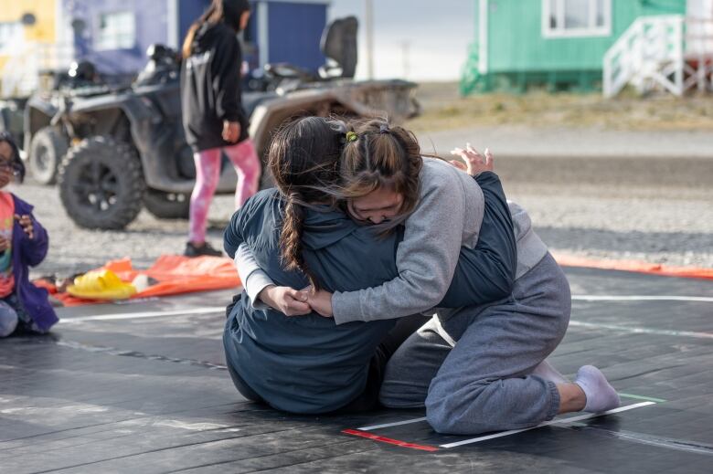 Two people engage in a wrestling match in Ulukhaktok, N.W.T.