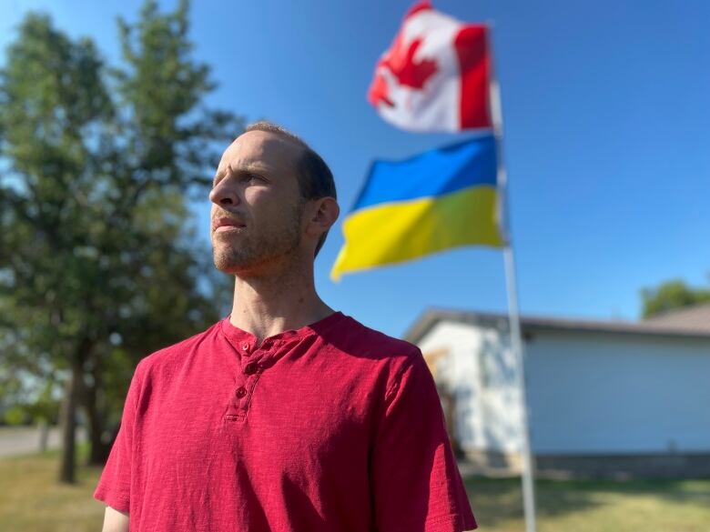 Will Hardy raised a Ukrainian flag with his Canadian one in the front yard of his Outlook, Sask. home after Canadian government officials told him his brother, Winton 