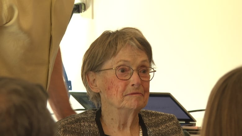 Profile shot of an elderly woman in glasses.