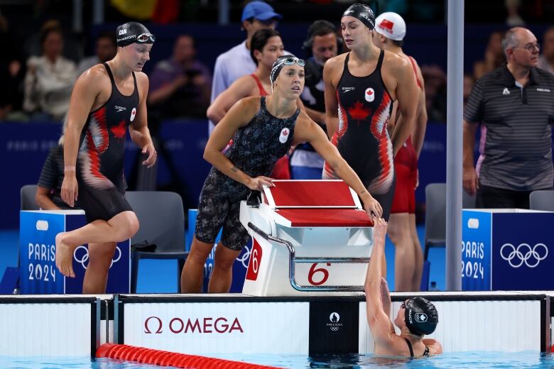 Four women's swimmers are shown.