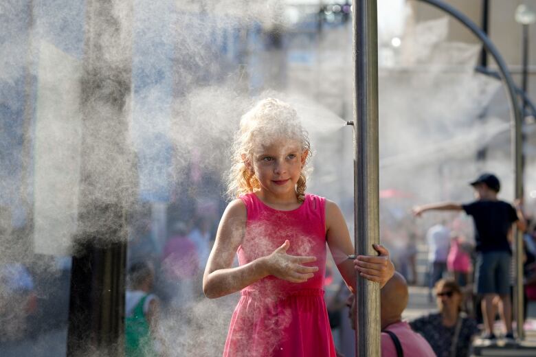 A girl cools off at a misting post